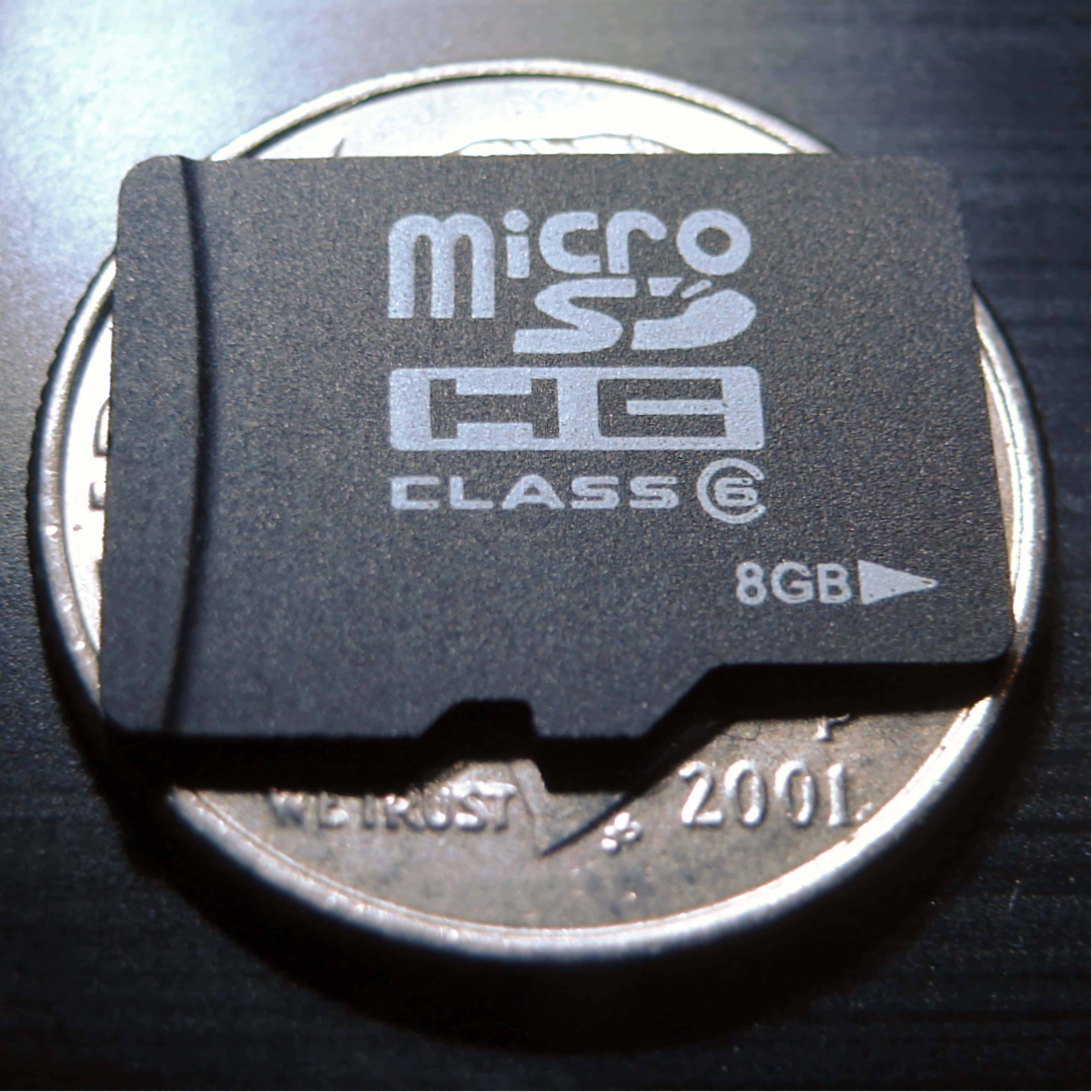 microSD card compared to a US quarter.