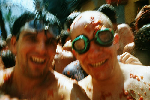 Revelers covered in tomatos at Tomatina Festival.