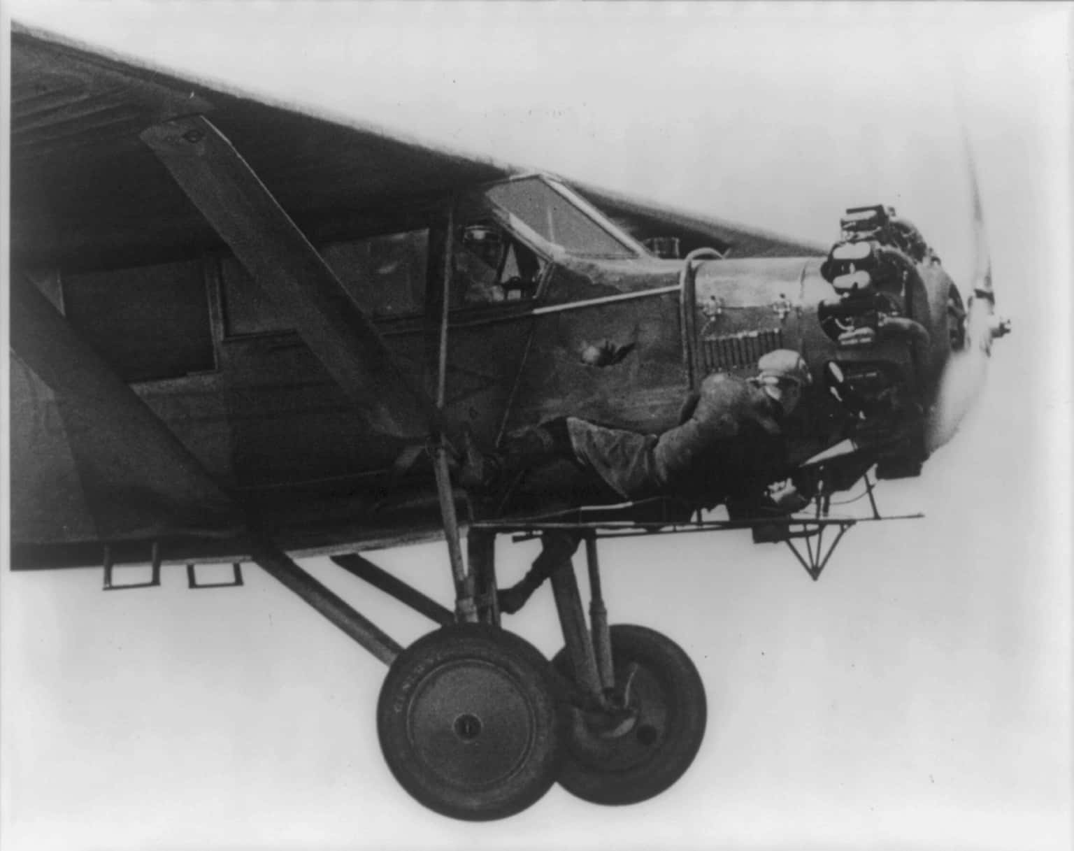 Kenneth Hunter greases the engine while his brother John flies the plane.